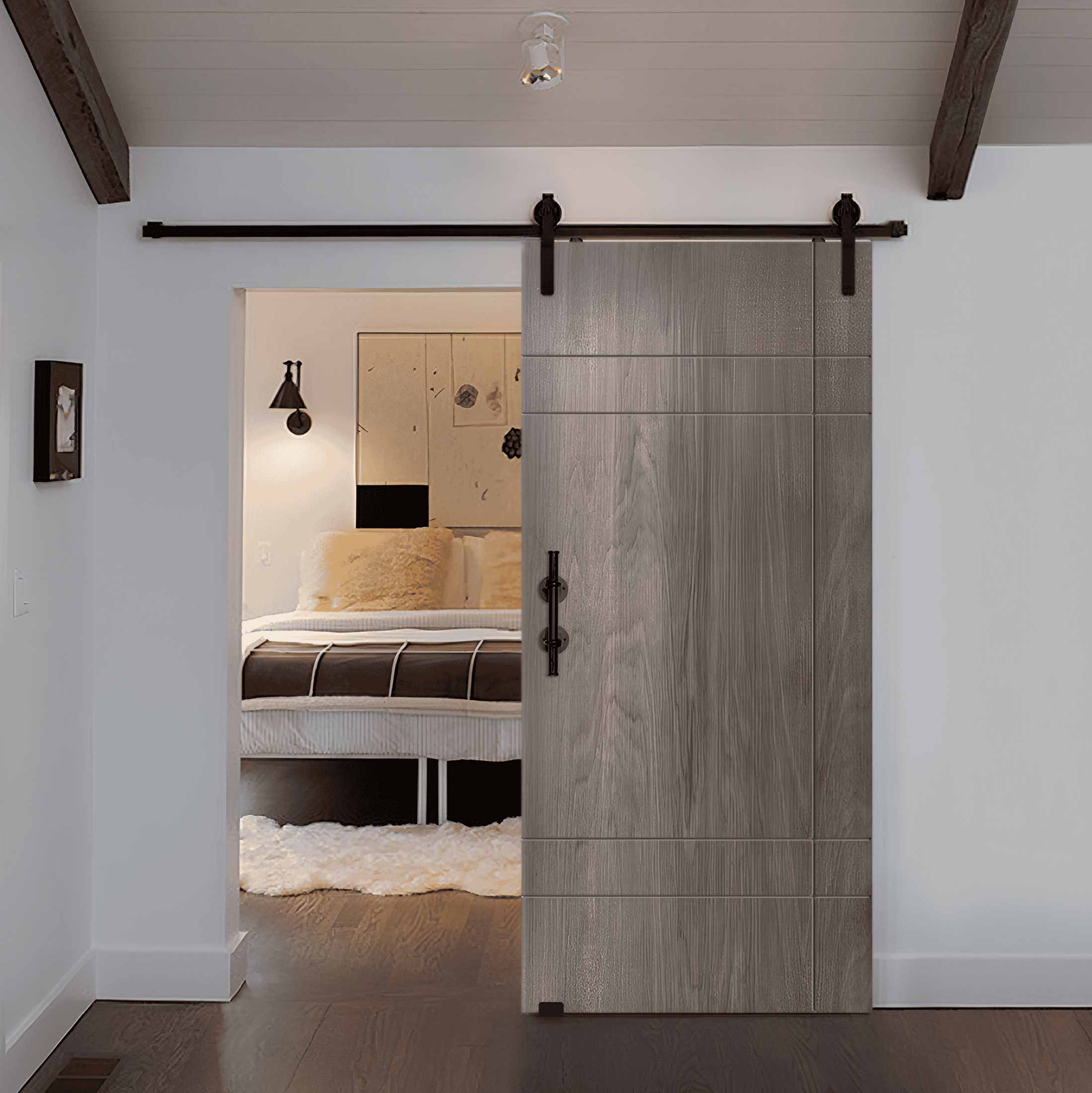 Gray sliding barn door with geometric grooved panels opening to a bedroom