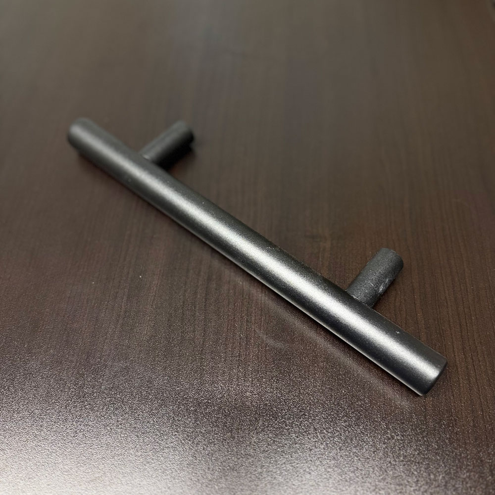 Brushed-metal tubular barn-door pull photographed from the front