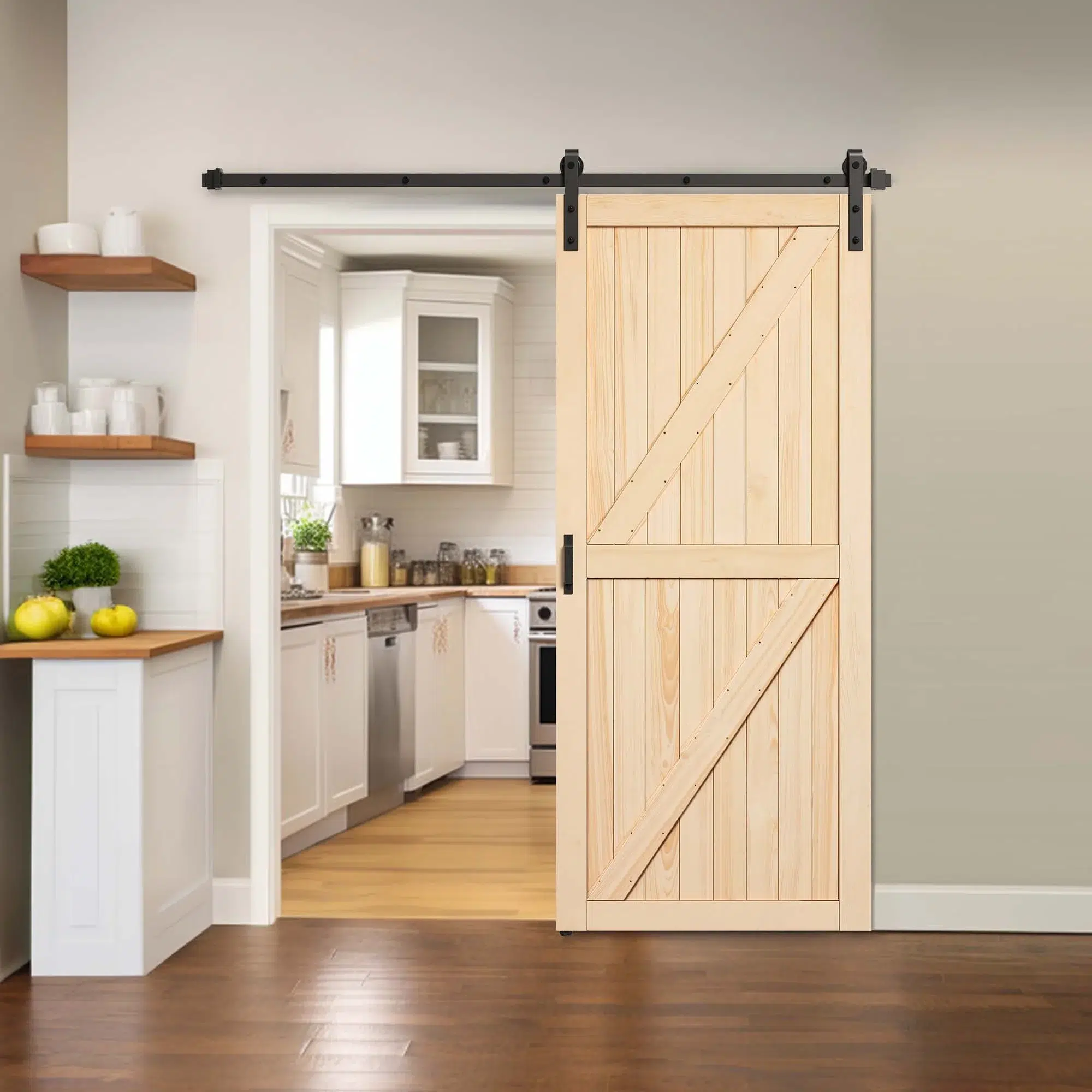 Natural wood sliding barn door with double diagonal braces beside a kitchen