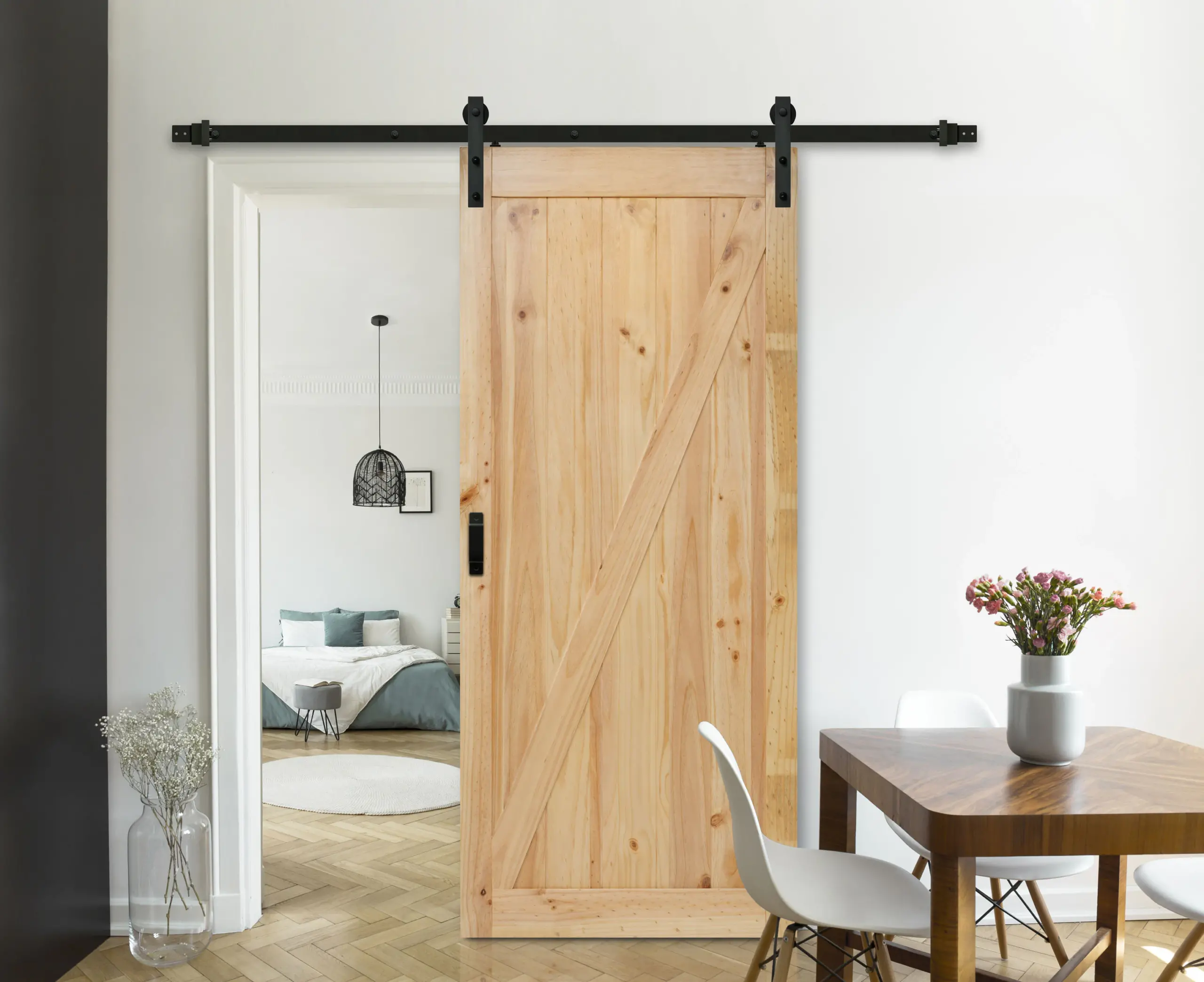 Light wood sliding barn door with a diagonal Z-brace between dining and bedroom spaces