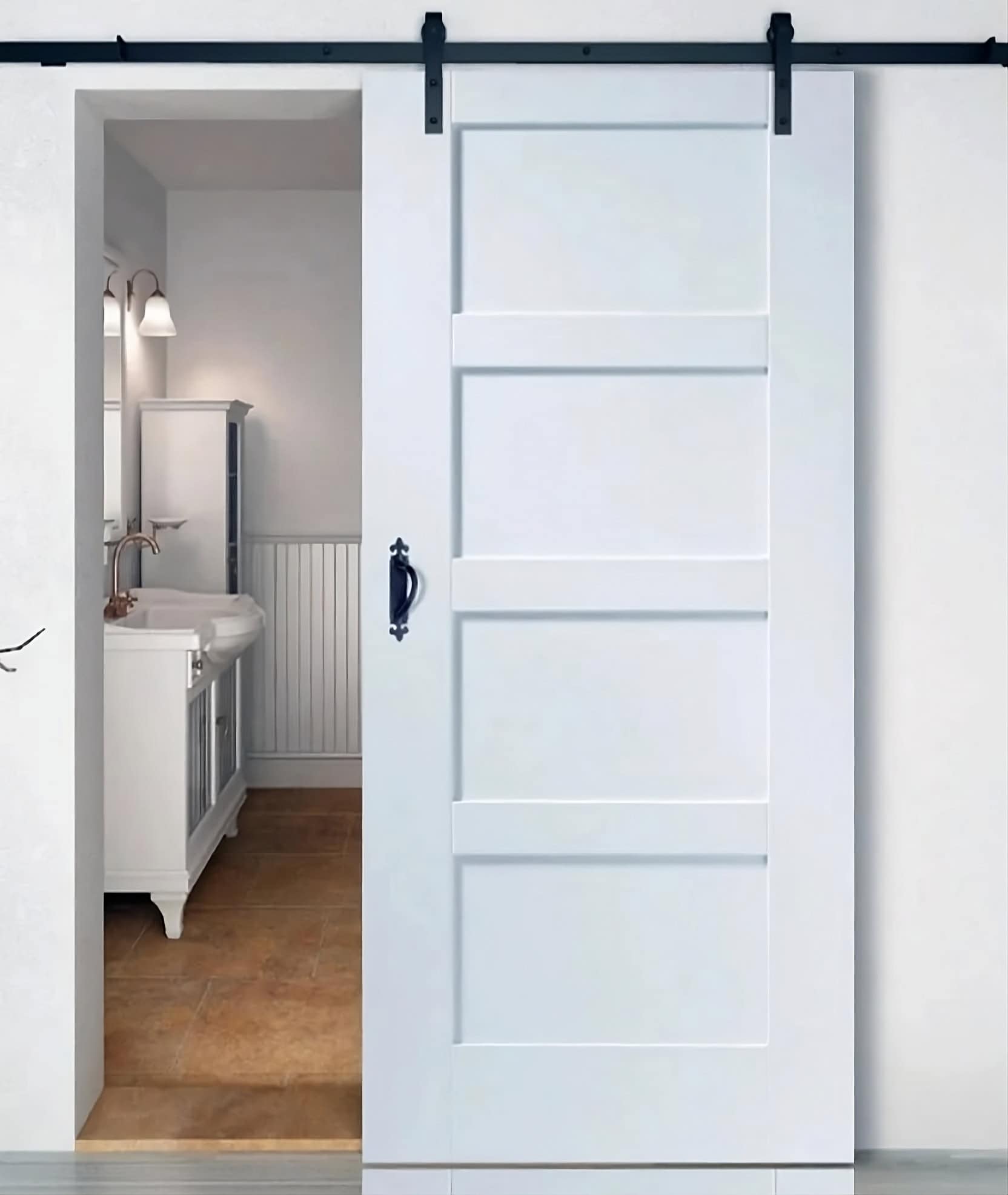 White four-panel sliding barn door partially open to a bathroom vanity