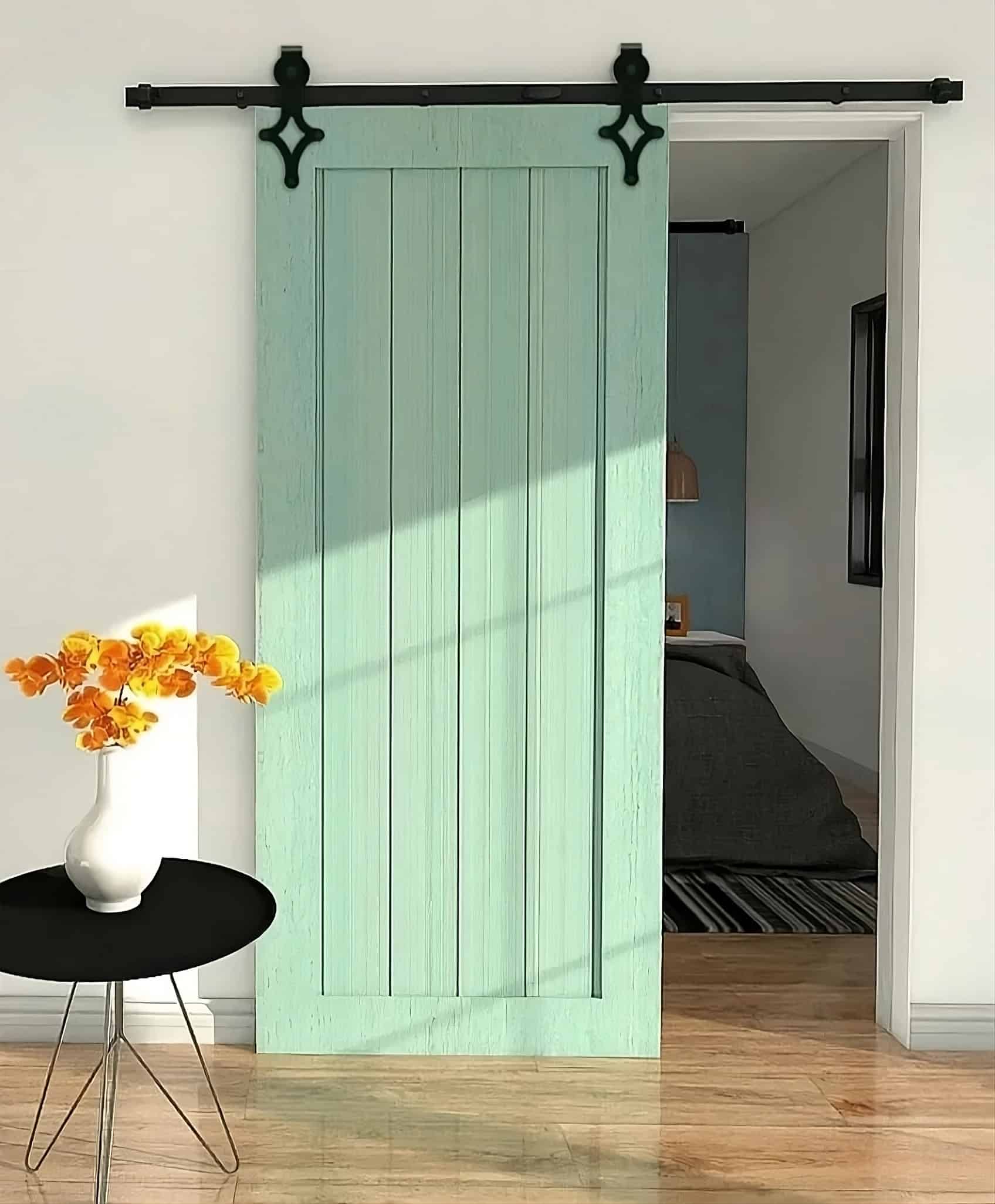 Mint green vertical-panel barn door partially revealing a bedroom