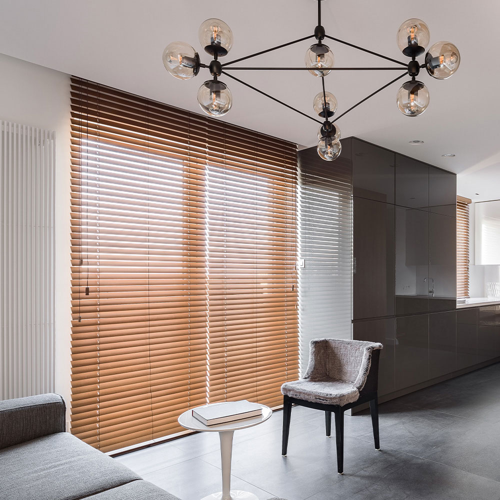 Brown faux wood blinds covering a kitchen window