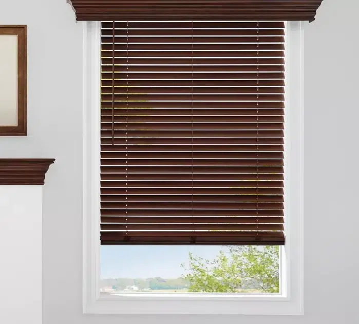 Brown faux wood blinds fitted within a residential window