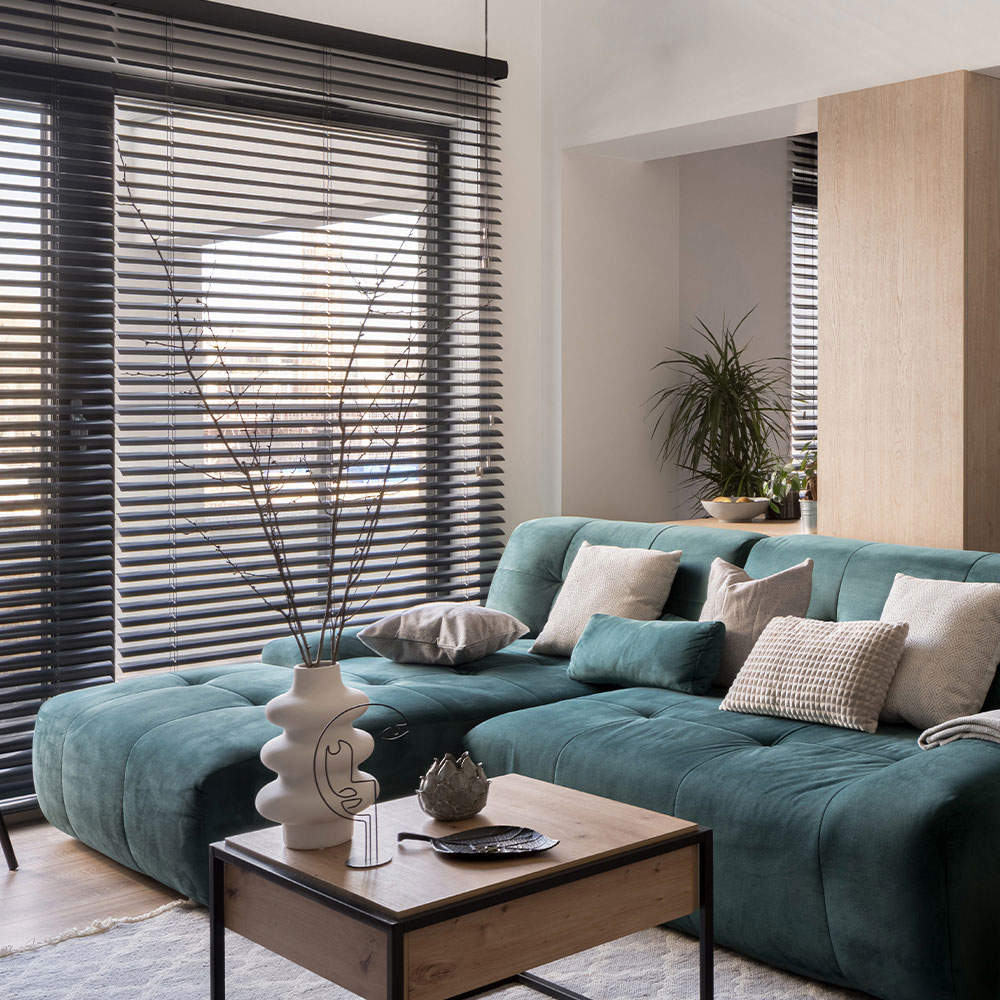 Dark faux wood blinds installed in a living room