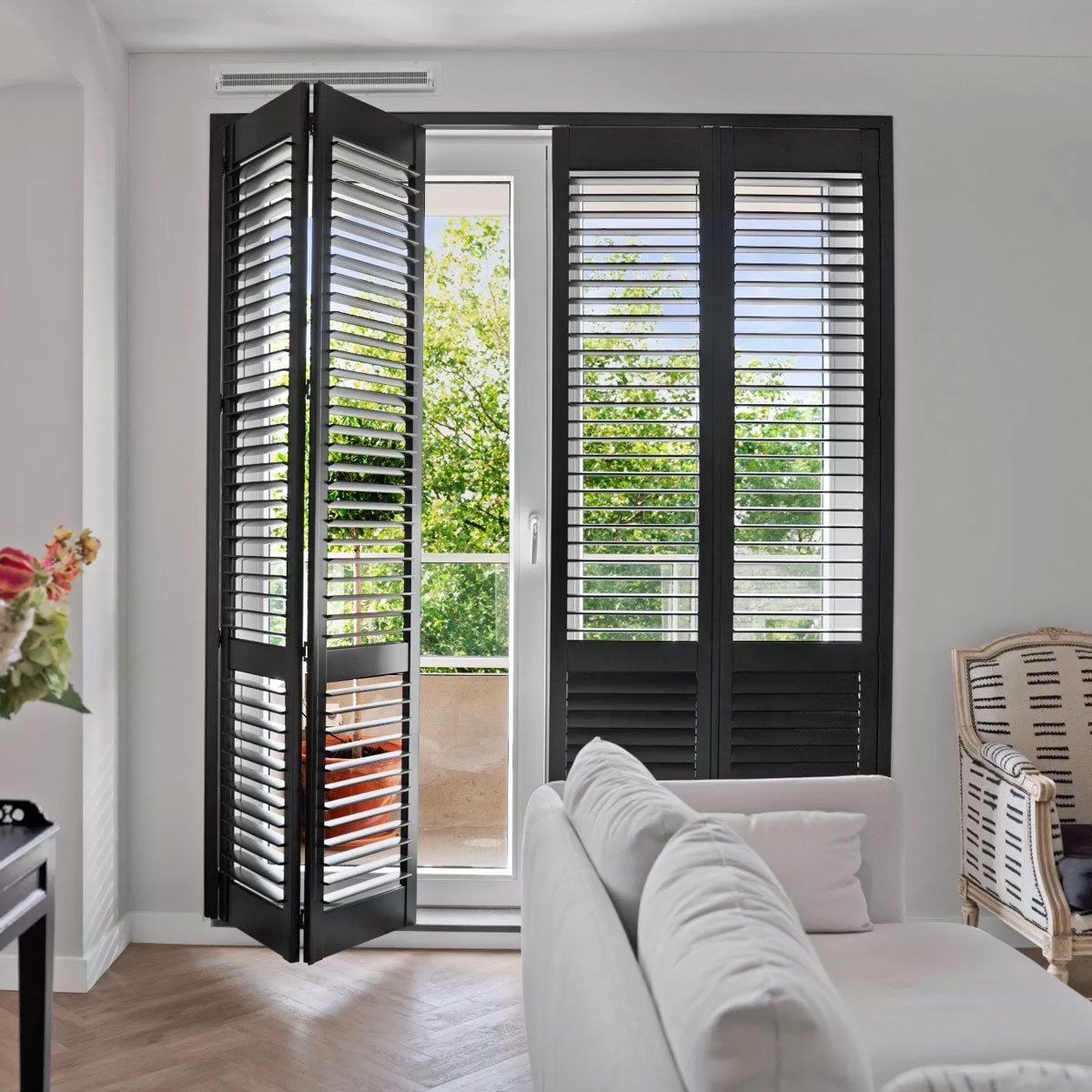 Black plantation shutters covering the glass panes of a door