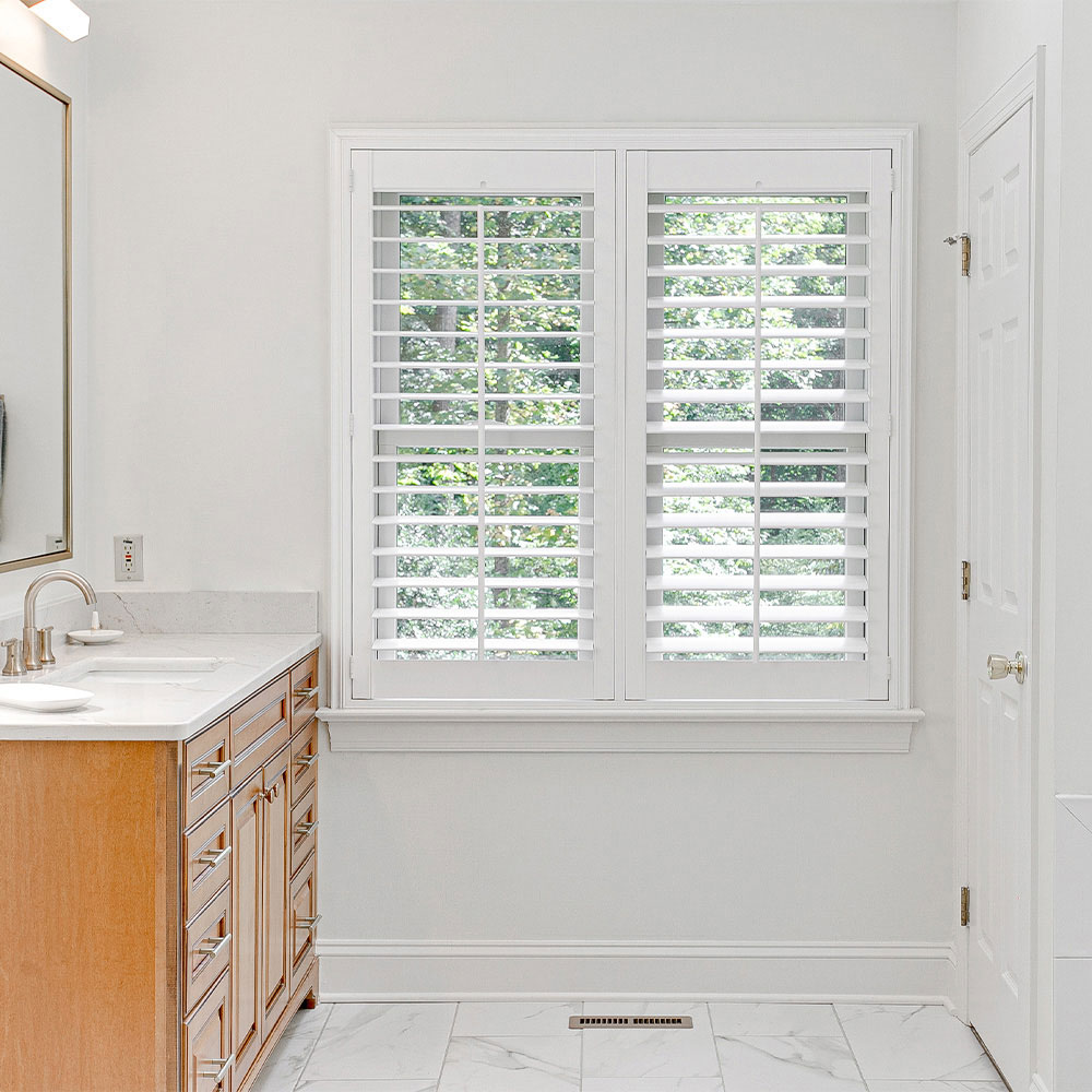 White plantation shutters installed beside a bathroom vanity