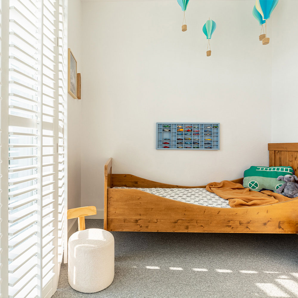 White plantation shutters installed in a child's bedroom