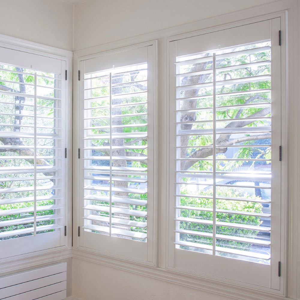 White shutters fitted across adjoining corner windows