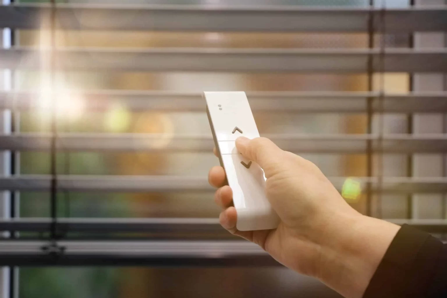 Handheld remote used to control motorized window shades