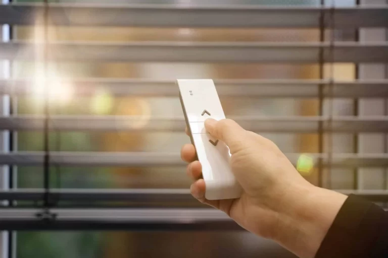 Remote-controlled roller shade positioned over a window