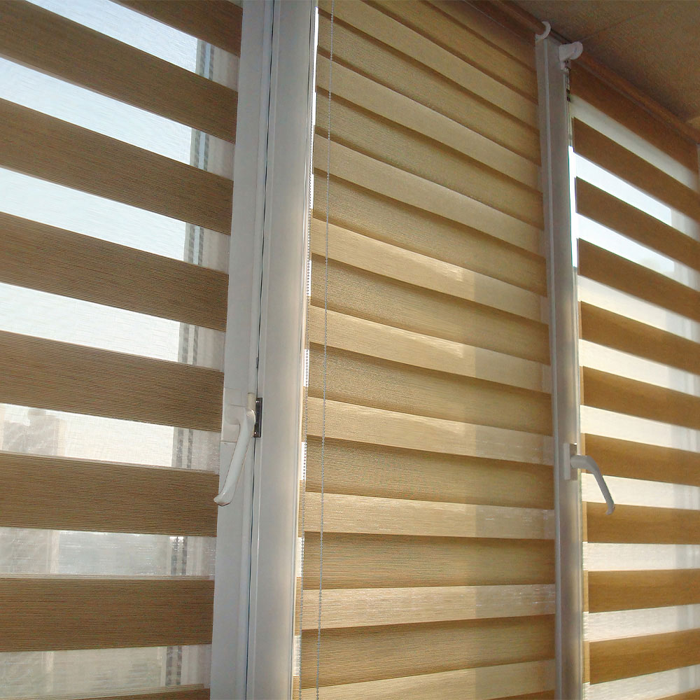 Beige zebra shades installed across adjacent windows
