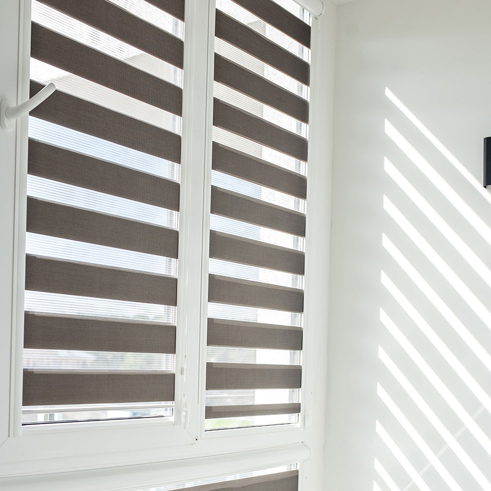 Gray zebra shades aligned over multiple windows